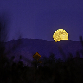 The Beaver Full Super Moon Rising near Four Peaks at Saguaro Lake